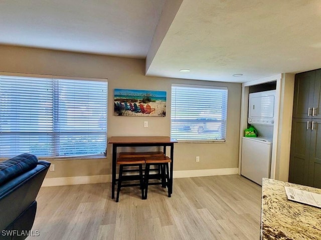 5023 SW 16th Pl Unit 101, Cape Coral, FL 33914 - dining area with stacked washer / drying machine and light wood-style floors