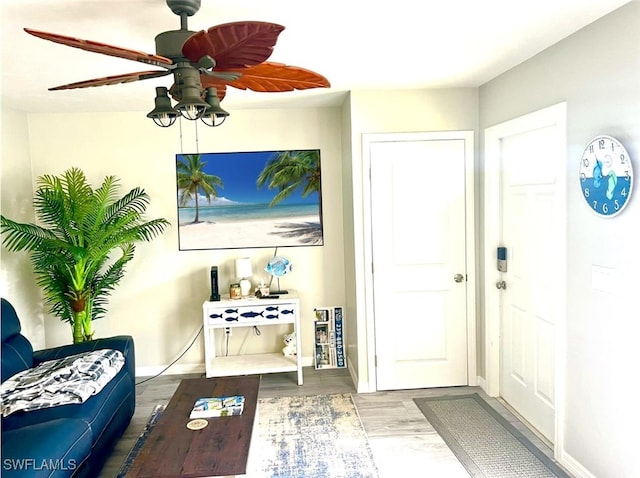 entryway with wood-type flooring and ceiling fan