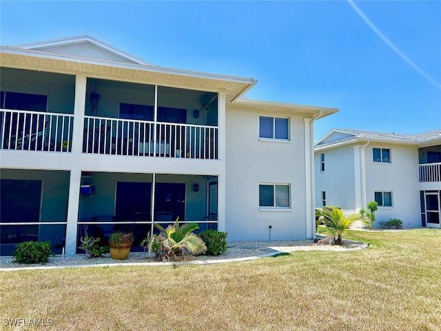 5023 SW 16th Pl Unit 101, Cape Coral, FL 33914 - back of property with stucco siding and a lawn