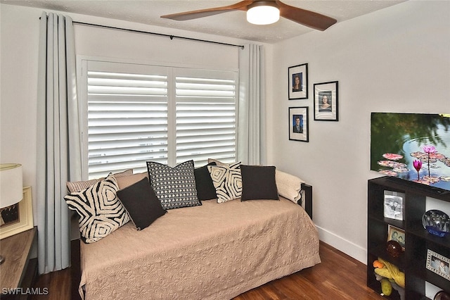 interior space with ceiling fan and dark hardwood / wood-style floors