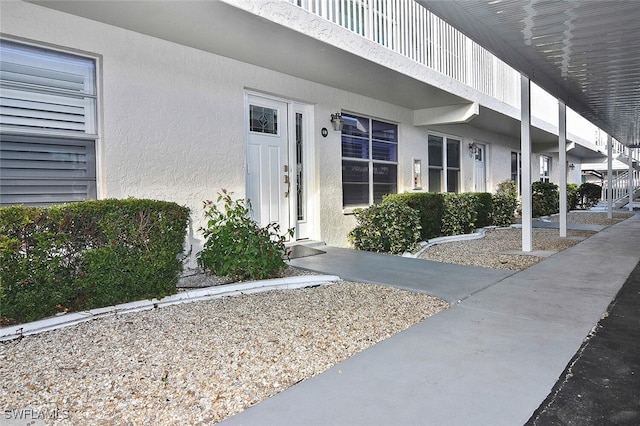 entrance to property with stucco siding