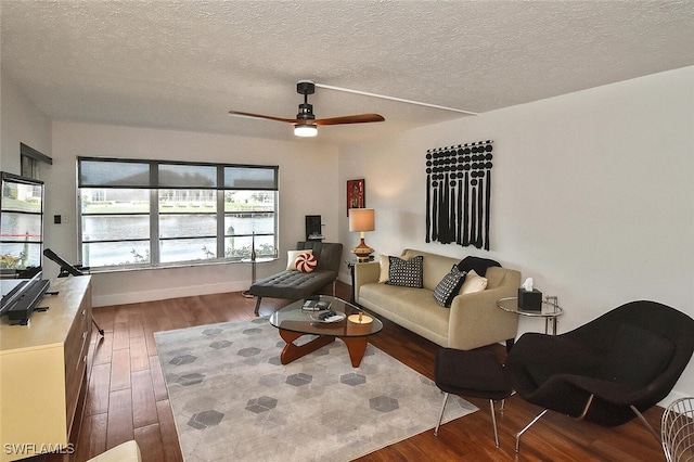 living room featuring a textured ceiling, ceiling fan, and hardwood / wood-style flooring