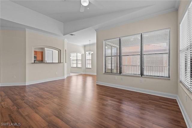 unfurnished living room with dark hardwood / wood-style floors, ornamental molding, and ceiling fan with notable chandelier