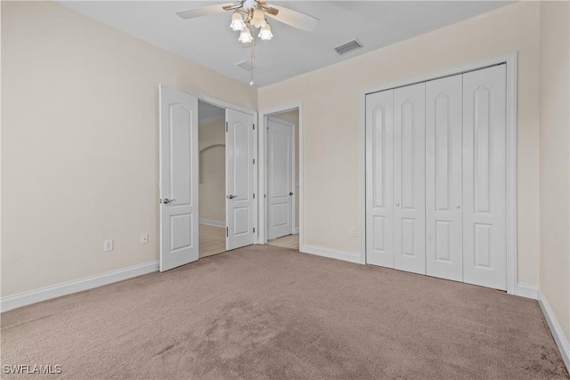 unfurnished bedroom with ceiling fan and light colored carpet