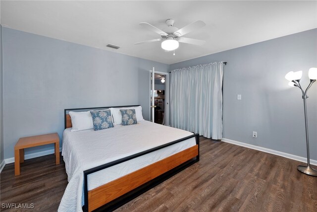 bedroom with ceiling fan and dark wood-type flooring