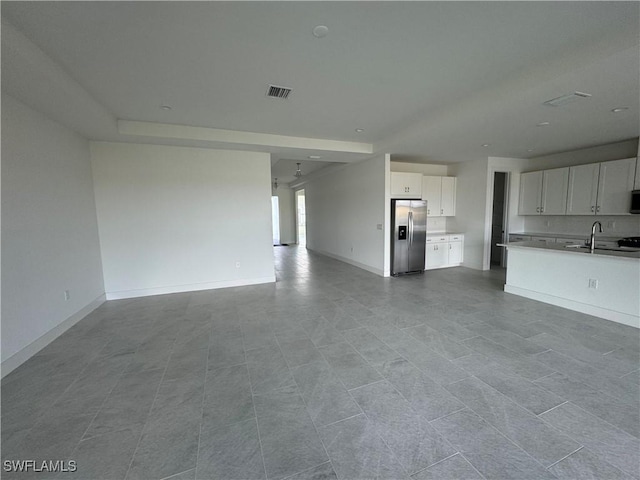 unfurnished living room with sink