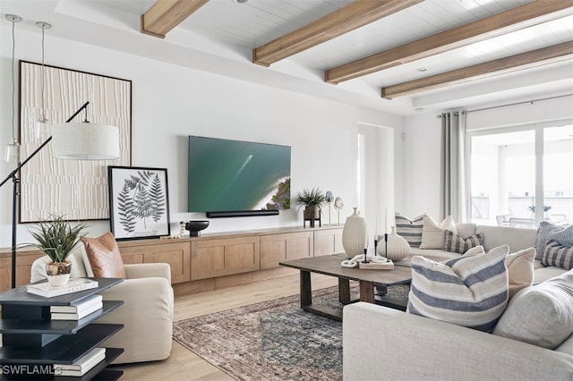 living room with light wood-style flooring and beamed ceiling