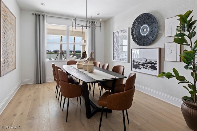44524 Little Blue Heron Way, Punta Gorda, FL 33982 - dining area featuring light wood-type flooring, recessed lighting, a notable chandelier, and baseboards