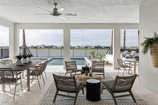 view of patio / terrace featuring a fenced in pool, outdoor dining space, and ceiling fan