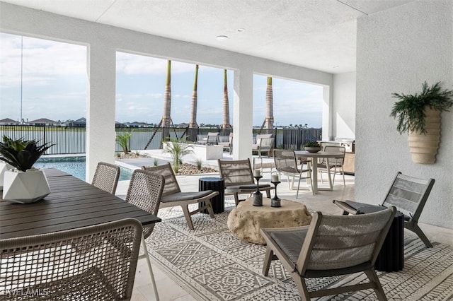 sunroom featuring a water view and a healthy amount of sunlight