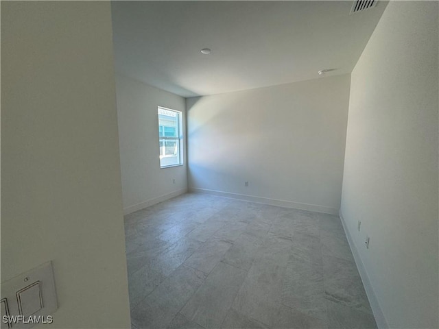 empty room with visible vents and baseboards