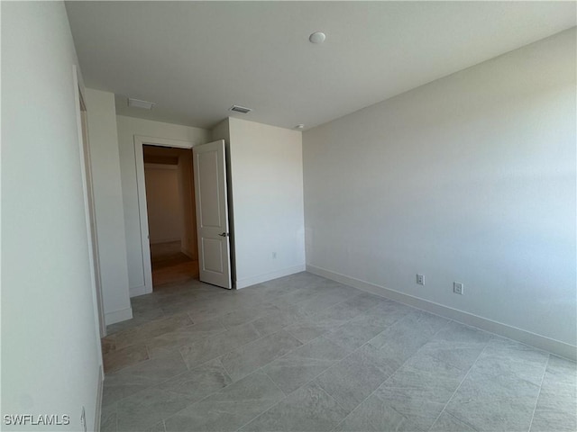 unfurnished bedroom featuring visible vents and baseboards