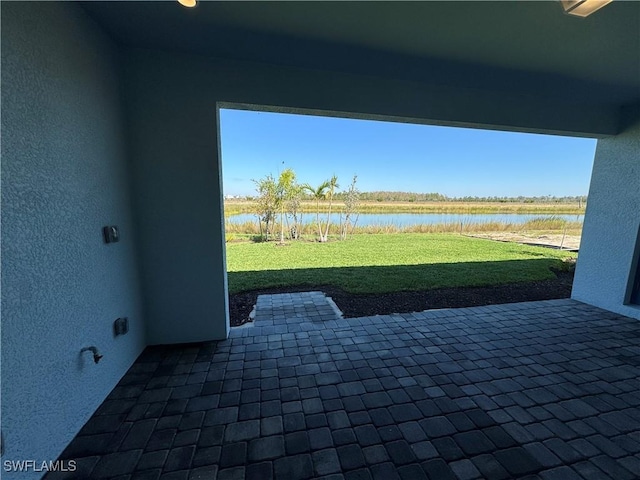 view of patio featuring a water view