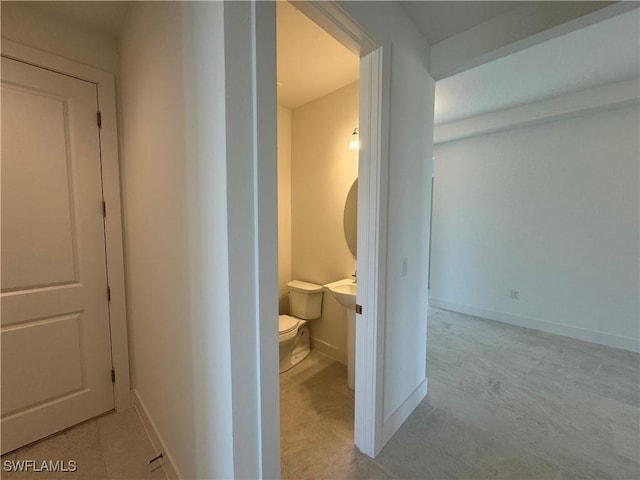 bathroom featuring toilet and baseboards