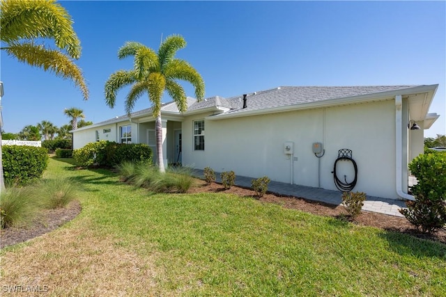 rear view of house featuring a yard