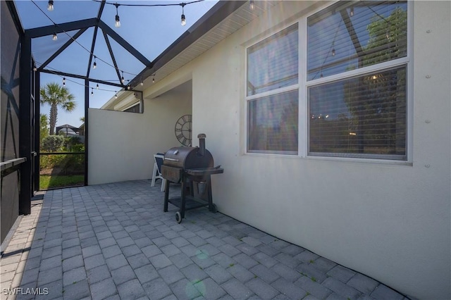 view of patio with a lanai and area for grilling