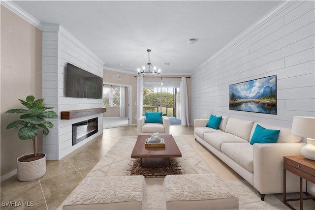 living room featuring crown molding, an inviting chandelier, a fireplace, and light tile patterned flooring