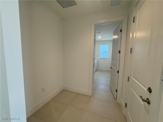 hall featuring light tile patterned flooring