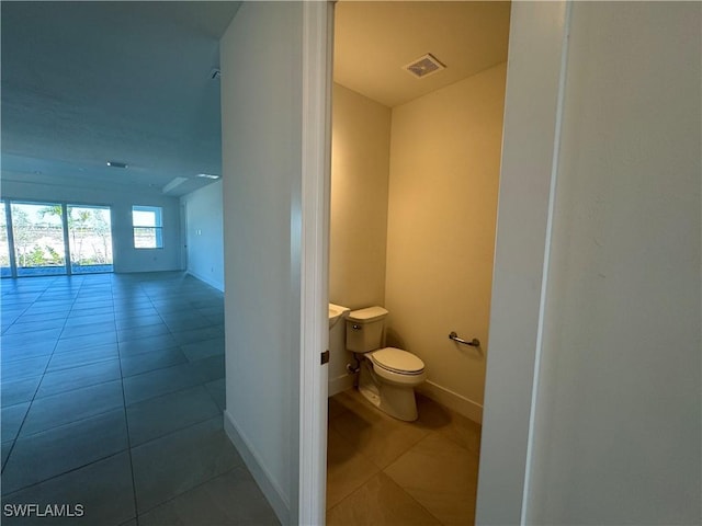 bathroom featuring tile patterned floors and toilet