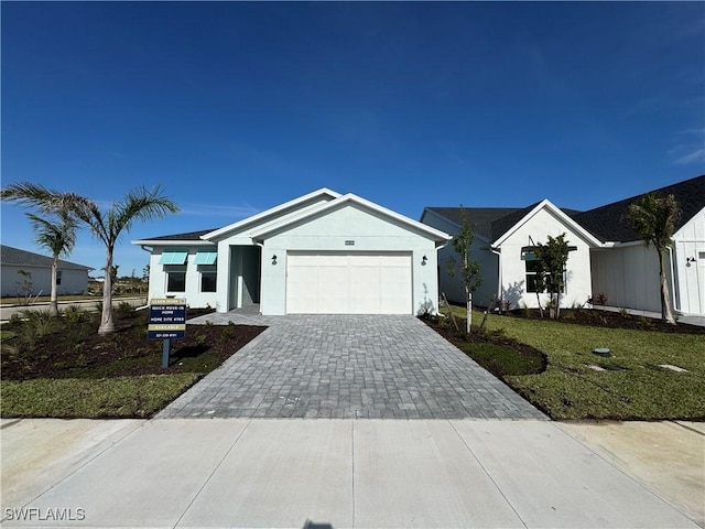 view of front of property featuring a front yard and a garage