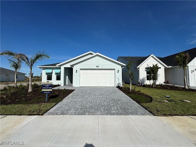 view of front of house featuring a front yard and a garage