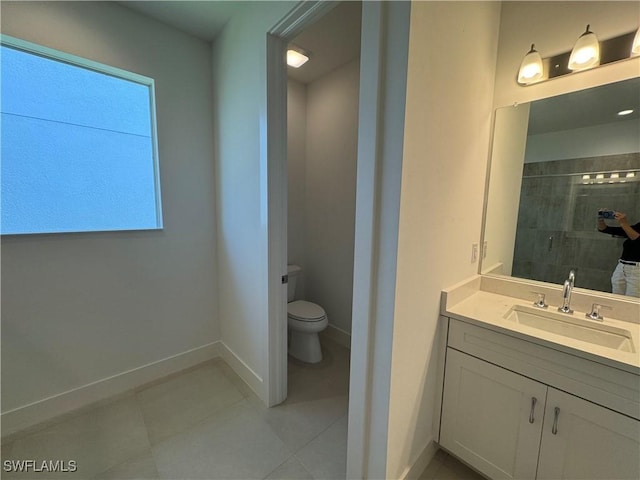 bathroom with tile patterned flooring, vanity, toilet, and a shower