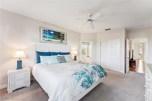 carpeted bedroom with connected bathroom, ceiling fan, and a closet