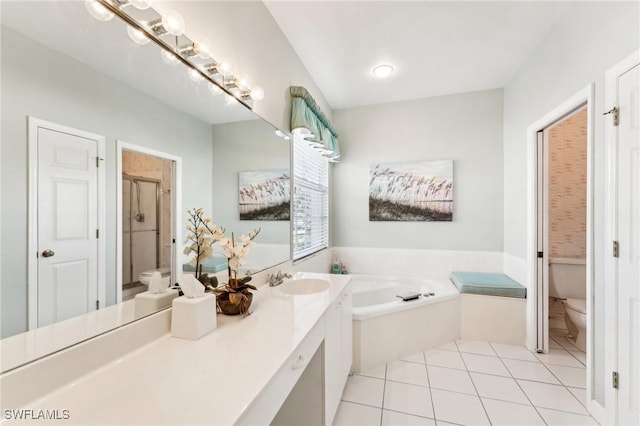 full bathroom featuring tile patterned floors, vanity, toilet, and independent shower and bath