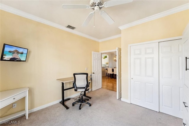 office space featuring ceiling fan, light colored carpet, and ornamental molding