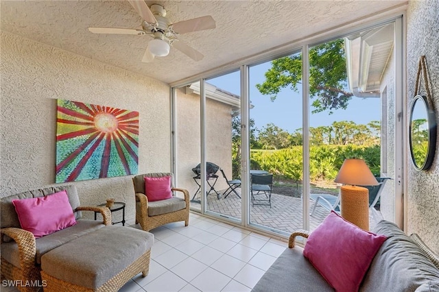 sunroom / solarium featuring ceiling fan