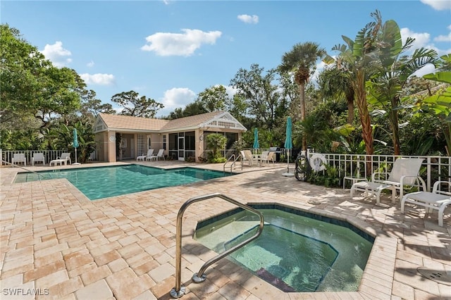 view of swimming pool featuring a community hot tub and a patio area