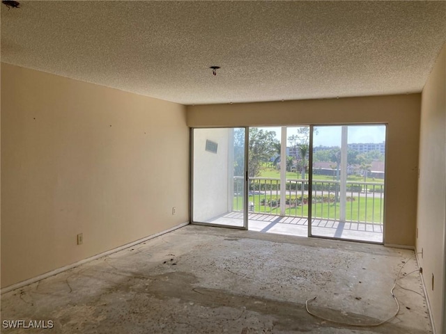 unfurnished room featuring a textured ceiling