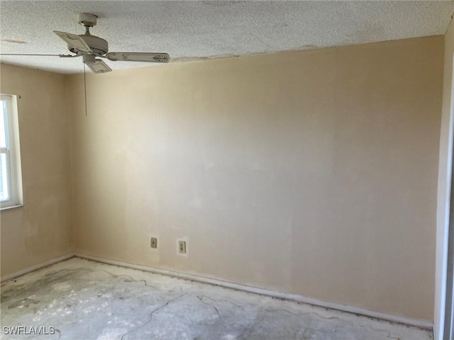 unfurnished room featuring a textured ceiling, concrete floors, and ceiling fan