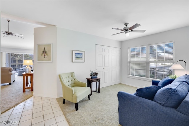 living room with ceiling fan and light tile patterned floors