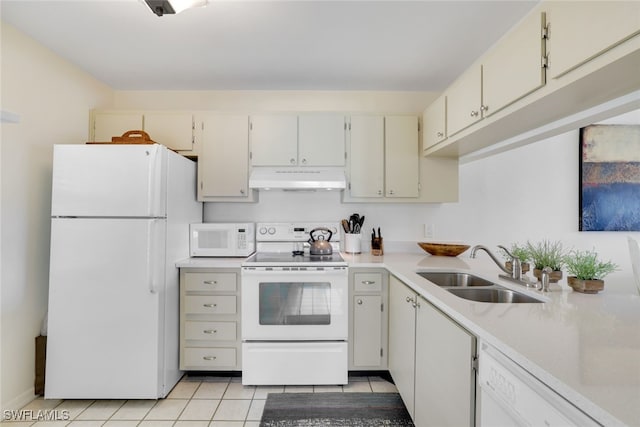 kitchen with sink, light tile patterned floors, and white appliances