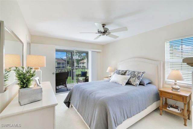 carpeted bedroom featuring access to outside, multiple windows, and ceiling fan