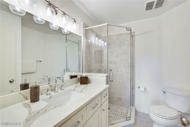 bathroom featuring vanity, toilet, and an enclosed shower