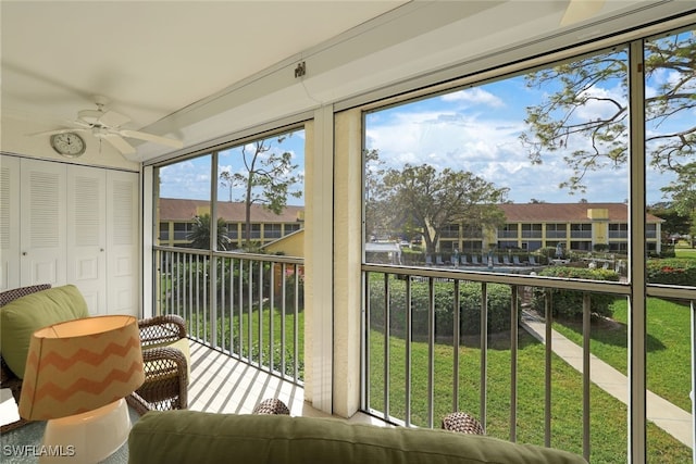 sunroom featuring ceiling fan