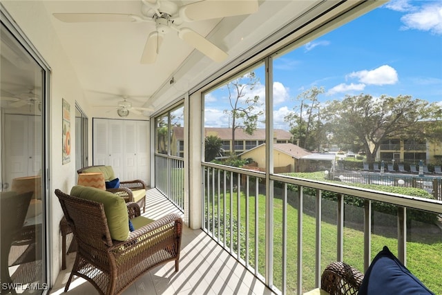 sunroom / solarium featuring ceiling fan