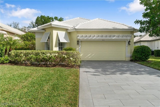 view of front of house with a garage and a front yard