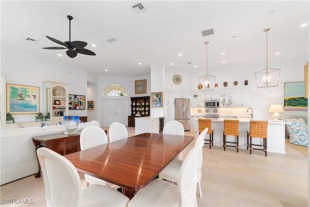 dining space with sink and ceiling fan