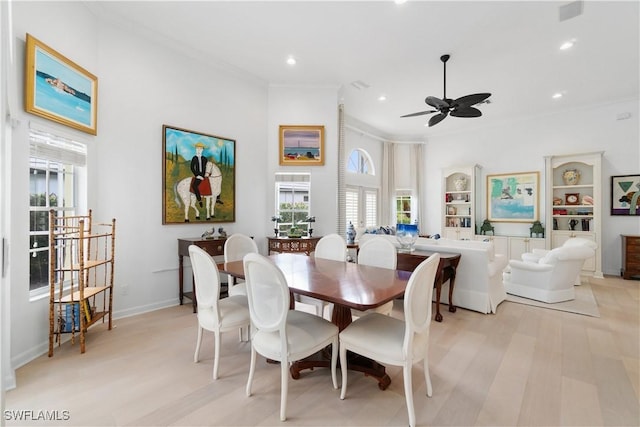 dining room featuring light hardwood / wood-style floors, ornamental molding, and ceiling fan