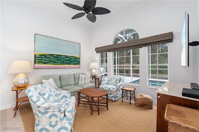 living room with ceiling fan and ornamental molding