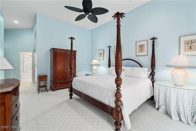 carpeted bedroom with ceiling fan, connected bathroom, and vaulted ceiling