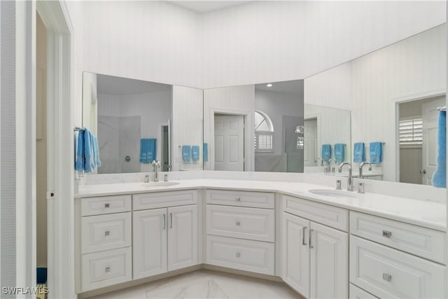 bathroom featuring walk in shower and vanity