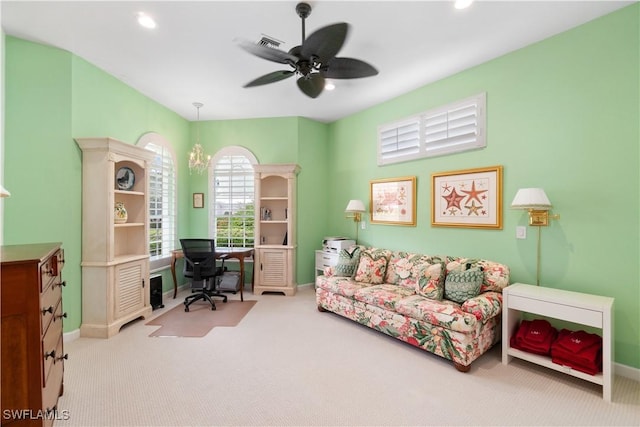 carpeted home office featuring ceiling fan