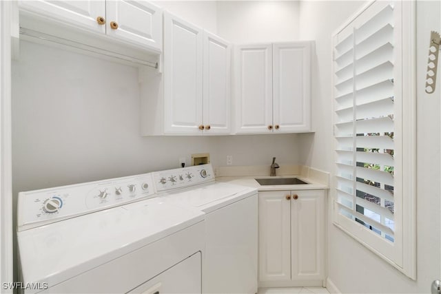 laundry area with cabinets, sink, and washing machine and dryer