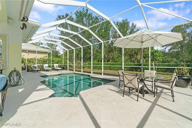 view of swimming pool with a patio and glass enclosure