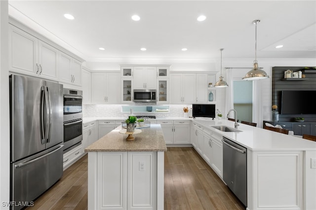 kitchen featuring sink, a center island, hanging light fixtures, and appliances with stainless steel finishes