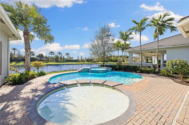 view of swimming pool with a water view, an in ground hot tub, and a patio